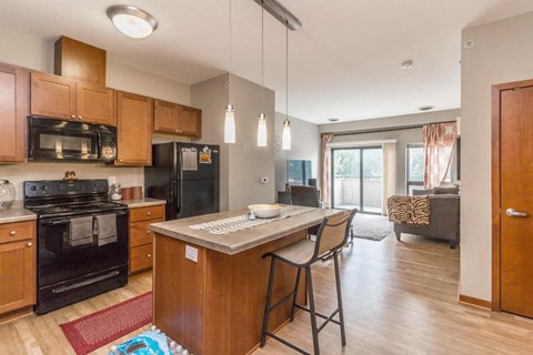a kitchen with a center island with two stools