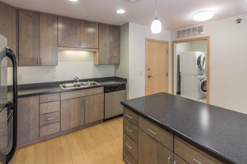 a kitchen with a counter top and a sink and a refrigerator