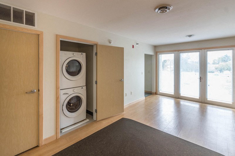a washer and dryer in an empty living room