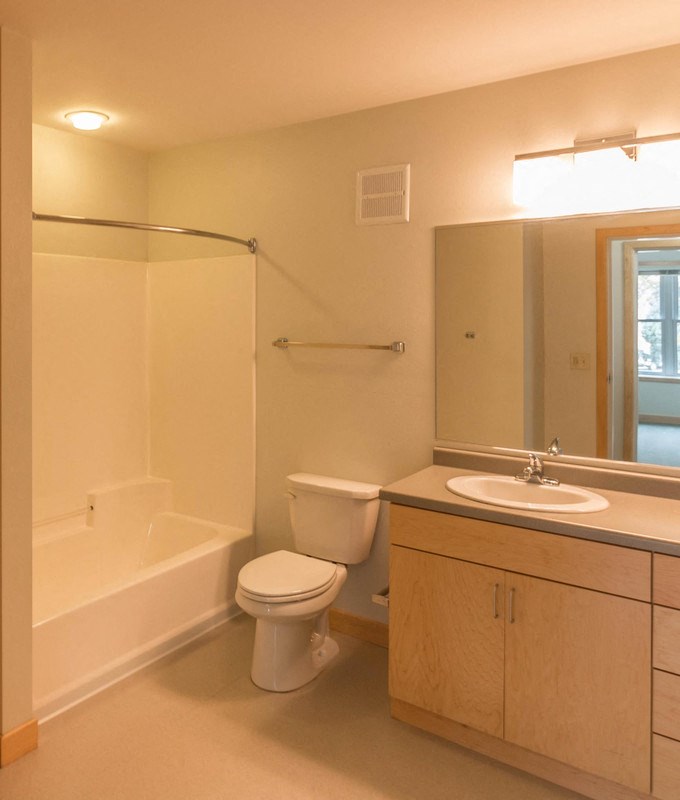 a bathroom with a toilet and a sink and a bath tub