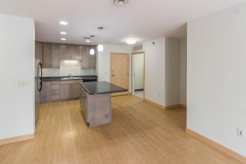an empty kitchen with an island in the middle of it