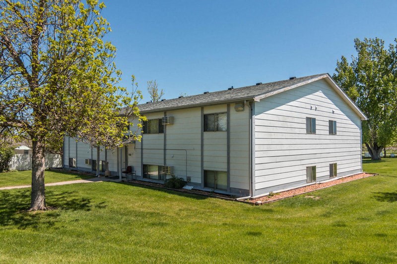 a white house with a tree in front of it