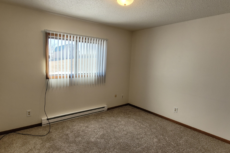the living room of an empty house with a window