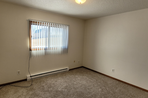 the living room of an empty house with a window
