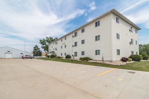 a large white building with a car parked in front of it