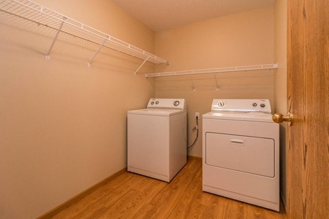 a laundry room with two washes and a dryer in it