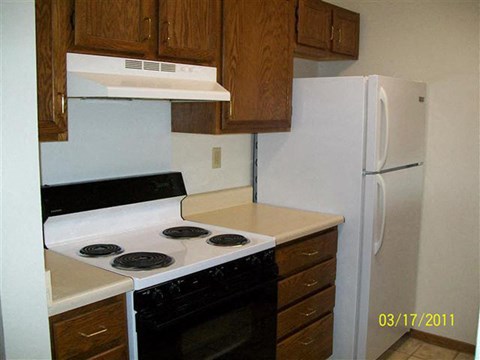 a kitchen with a stove and a refrigerator