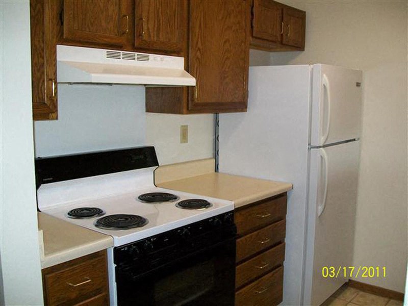 a kitchen with a stove and a refrigerator
