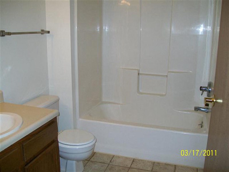 a bathroom with a toilet and a tub and a sink