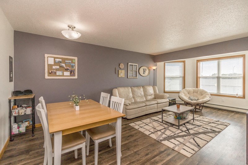 a living room and dining room with a couch and a table