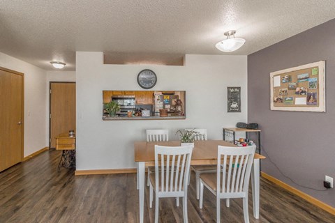 a dining room with a wooden table and chairs