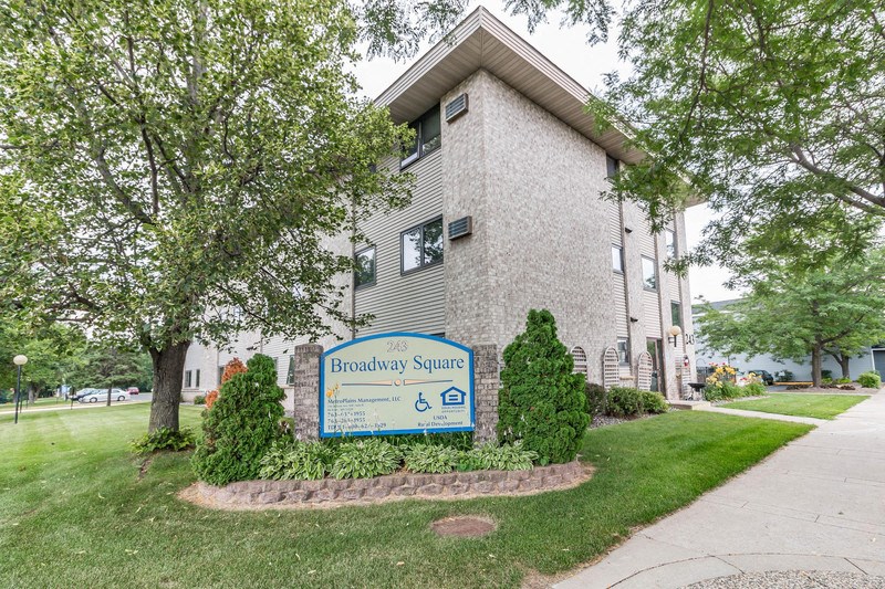 a building with a blue and white sign in front of it