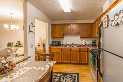 a kitchen with wooden cabinets and stainless steel appliances