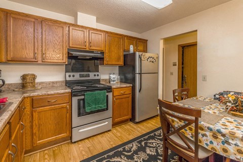 a kitchen with stainless steel appliances and wooden cabinets