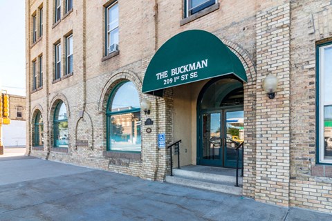 a brick building with a green awning on the front of it
