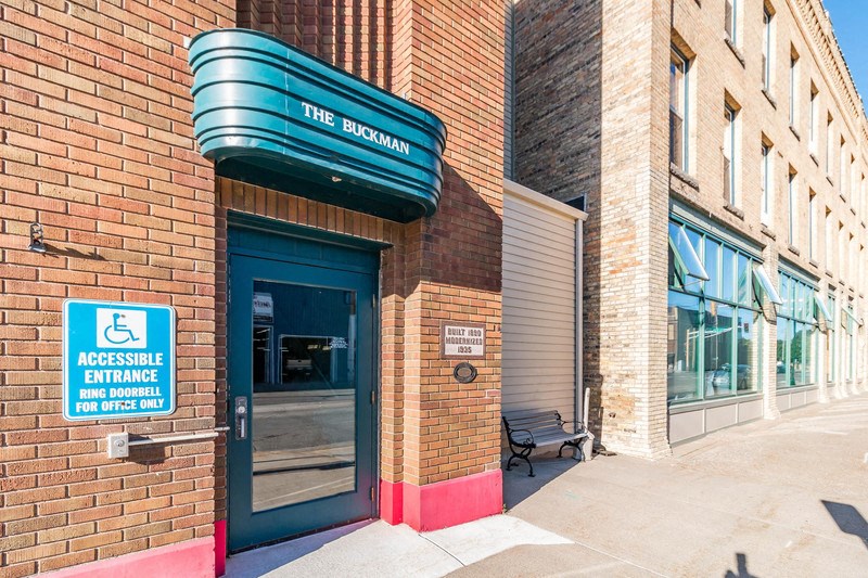 a brick building with a blue sign on top of it