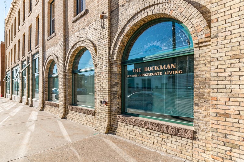 a brick building with a large window with a sign that reads the incoherent brewing