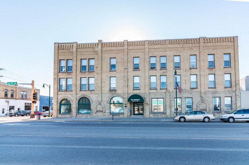 a large brick building on the corner of a city street
