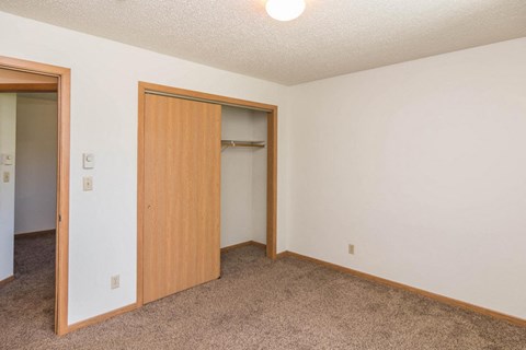 a bedroom with a closet and a door to a closet