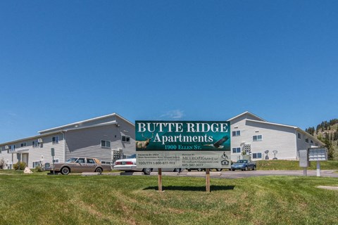 a sign apartments in front of a building
