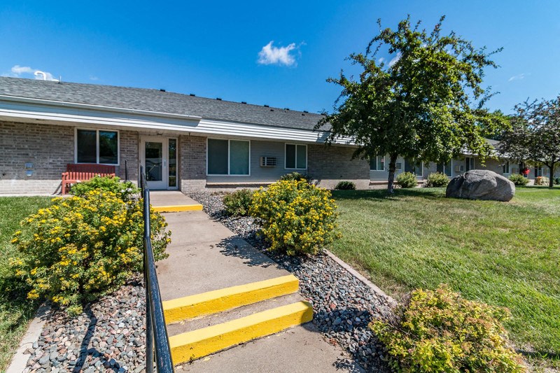 a brick house with yellow steps in front of it