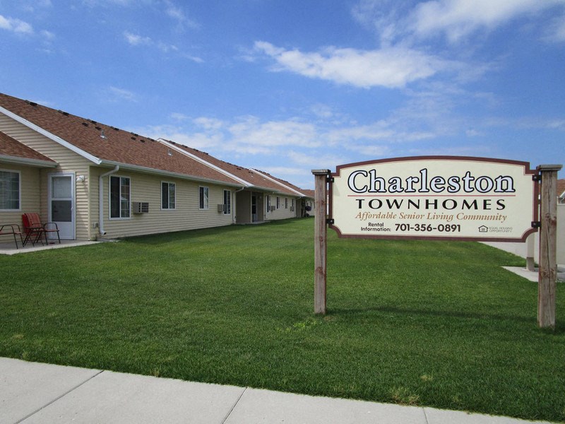 a sign sits in front of a green lawn