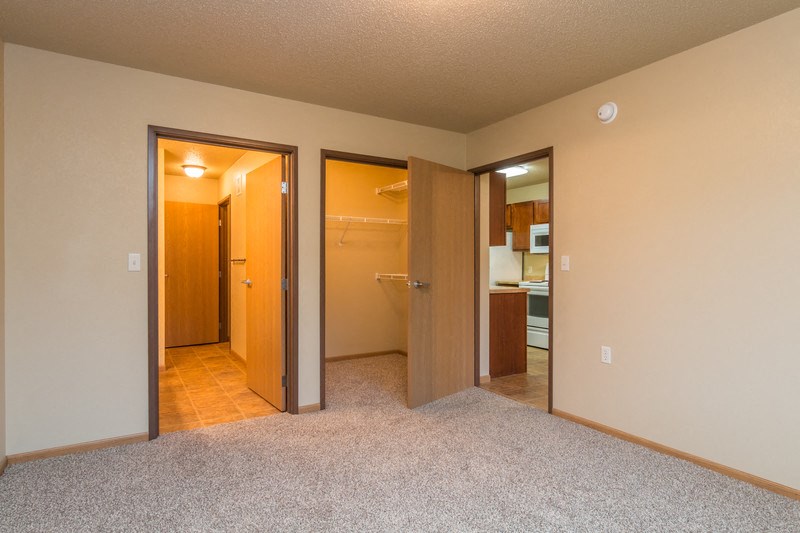 a empty room with a bathroom and a closet