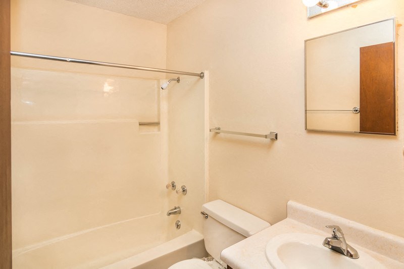 a bathroom with a shower and a sink and a toilet