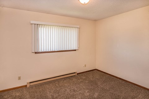 the living room of an empty house with a window