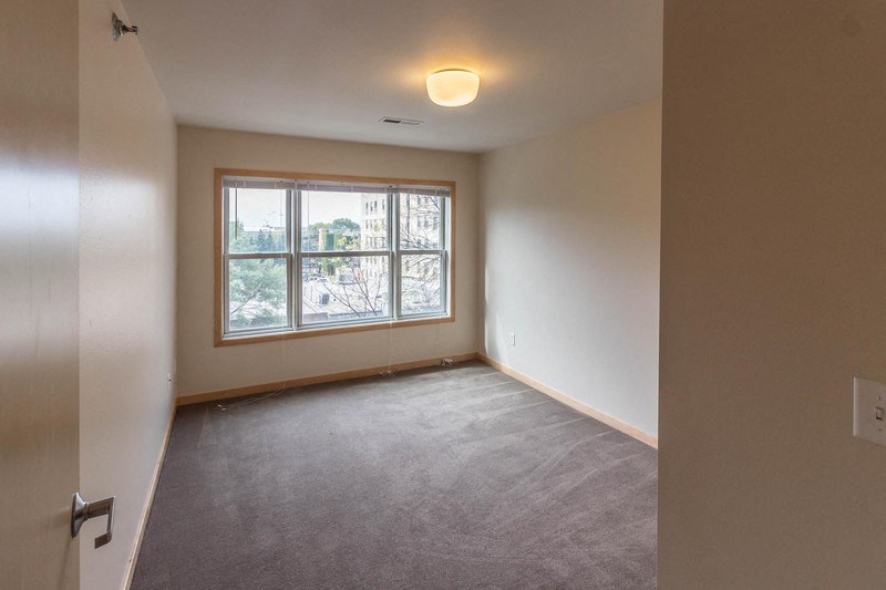 the living room of an empty house with a window