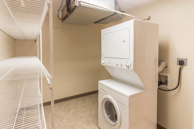 a washer and dryer in a laundry room with a closet