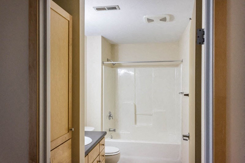 a bathroom with a shower and a toilet and a sink