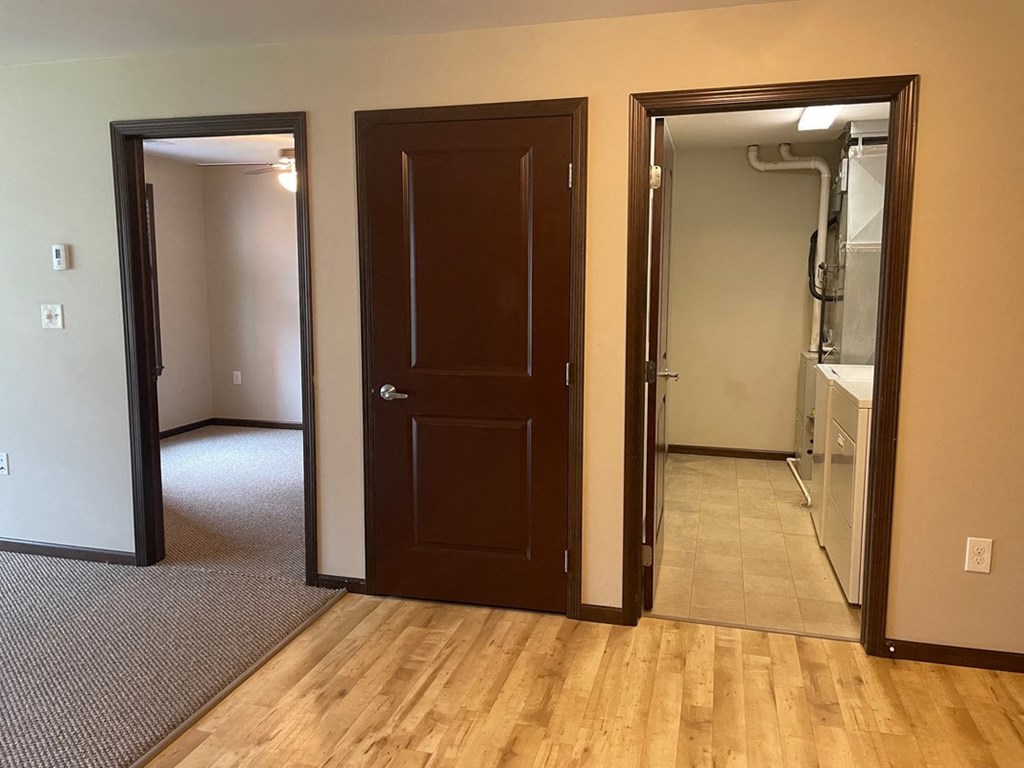 a bedroom and a bathroom with a closet and a shower