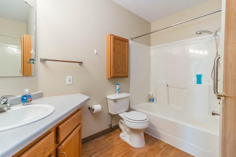 a bathroom with a toilet and a tub and a sink