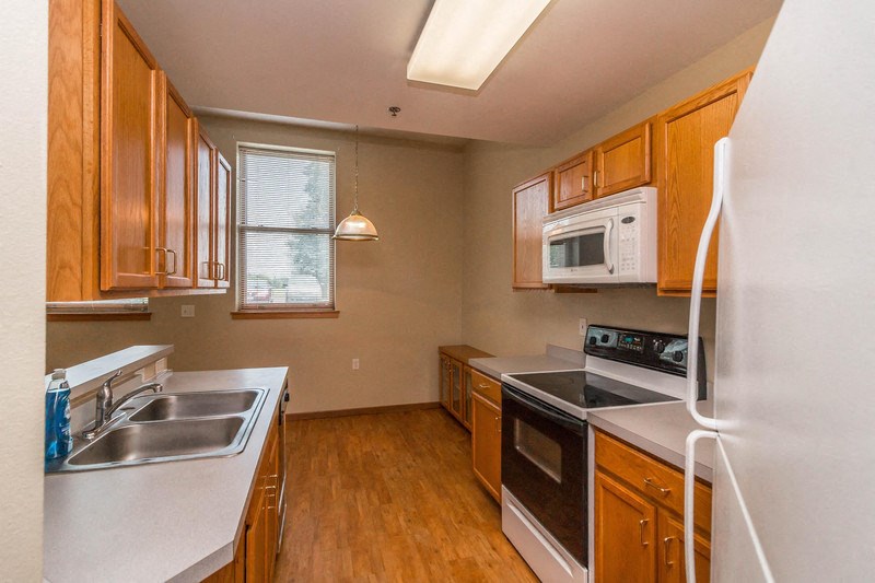 a kitchen with a stove microwave and a sink