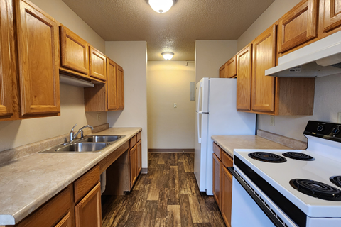 a kitchen with a stove sink and refrigerator