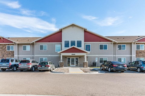 a large building with cars parked in front of it