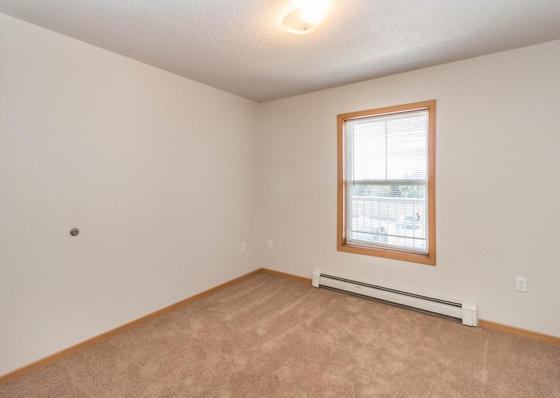 the living room of an empty house with a window