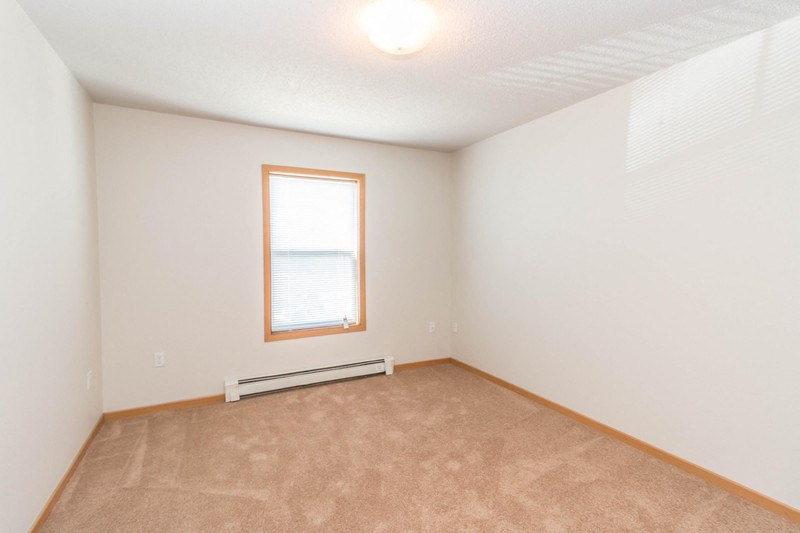 the living room of an empty house with a window
