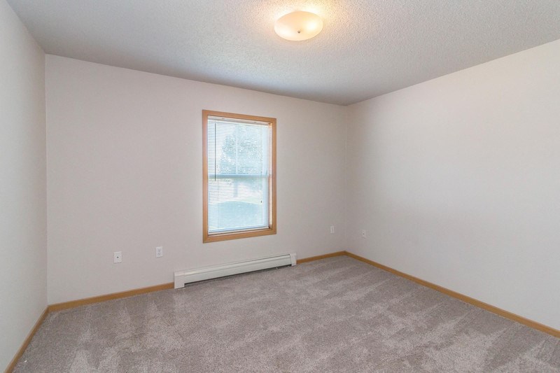 the living room of an empty house with a window