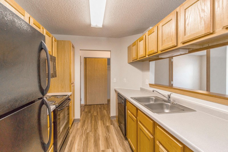 a kitchen with a sink and a refrigerator