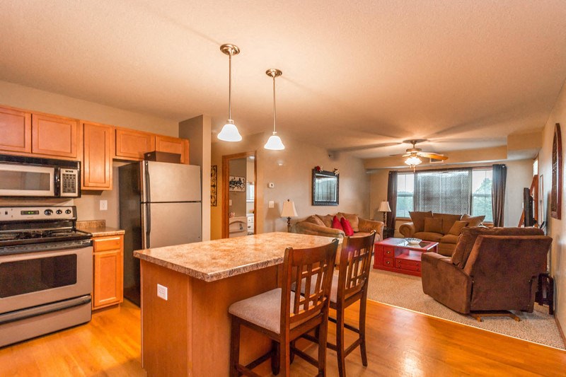 a kitchen with a center island and a living room