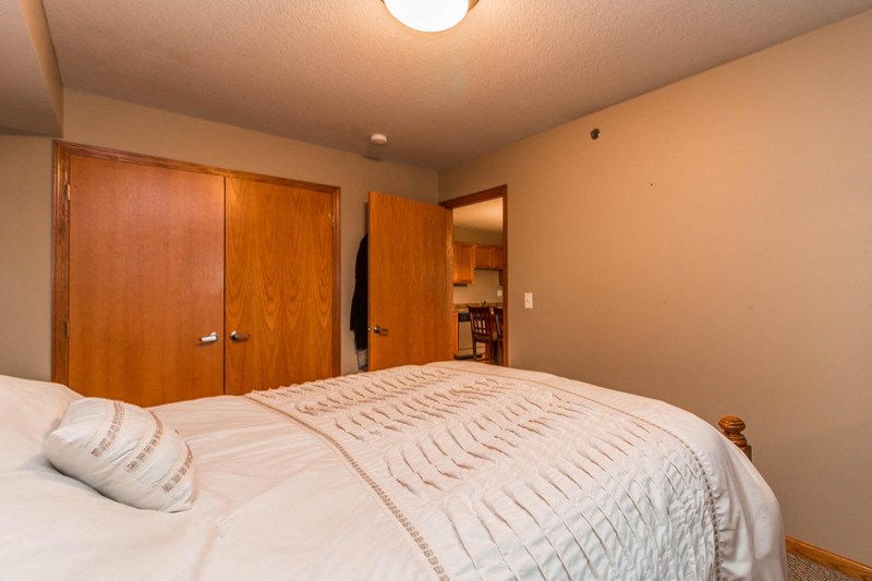 a bedroom with a large bed and a closet