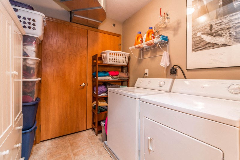 a washer and dryer in a laundry room with a closet