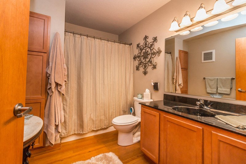 a bathroom with a toilet and a sink and a shower