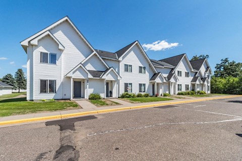 a row of white houses on the side of a street