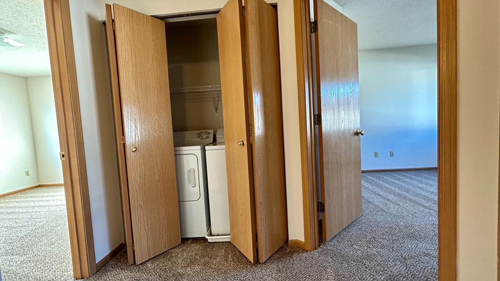 a kitchen with a washer and dryer in a closet