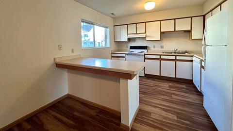 an empty kitchen with an island in the middle of it