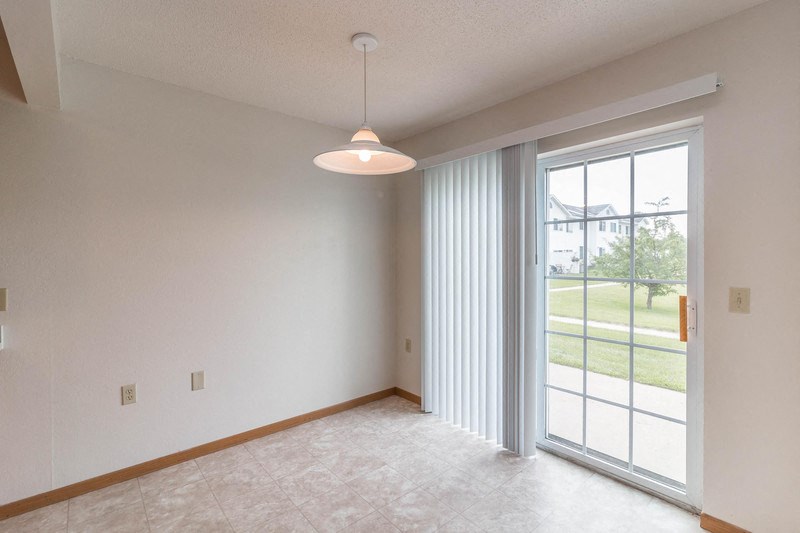 the living room of an empty house with a large window