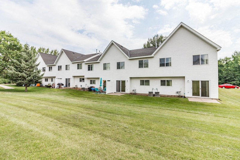 a large white house with a lawn in front of it